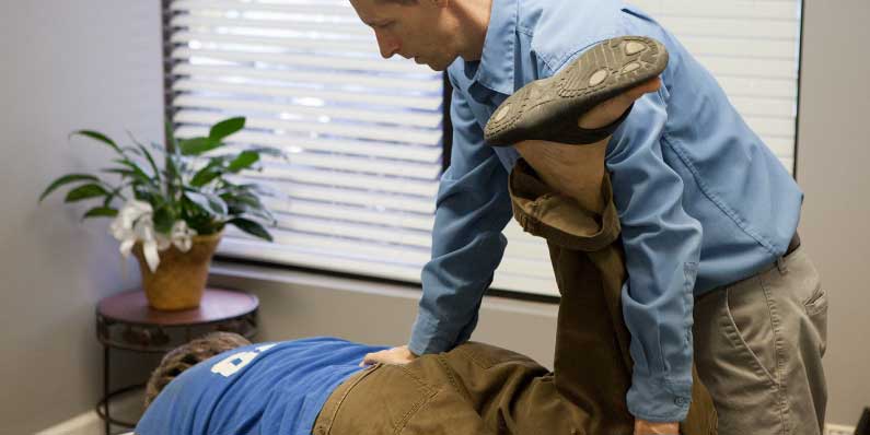 chiropractor adjusts man at foundation chiropractic